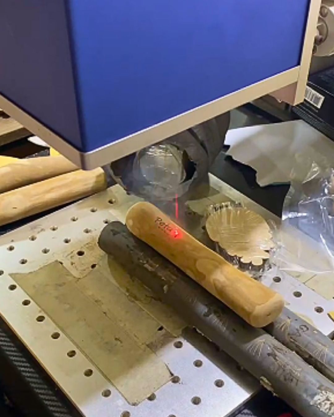 Laser engraving a custom logo onto a coffee wood chew