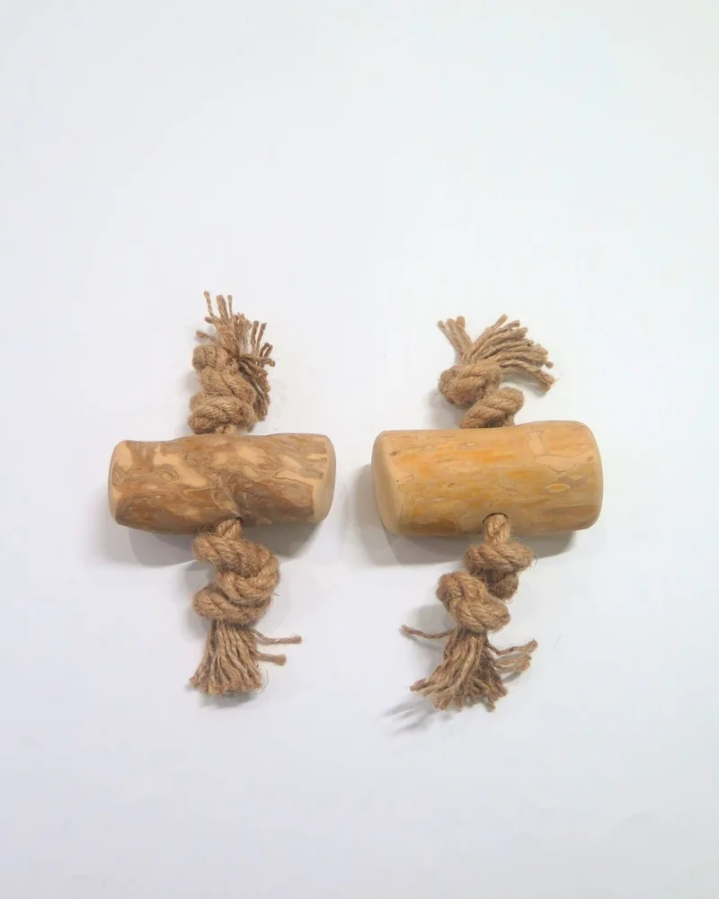 Two coffee wood toys with knotted rope ends on a light background